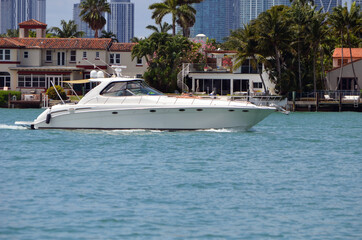 Fototapeta na wymiar Luxury motor yacht cruising on Biscayne Bay off of RivoAlto Island in Miami Beach,Florida