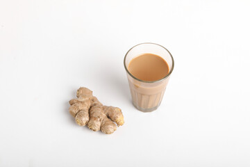 Glass cup of hot ginger tea with ginger rhizome (root) sliced isolated on white background.