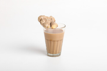 Glass cup of hot ginger tea with ginger rhizome (root) sliced isolated on white background.