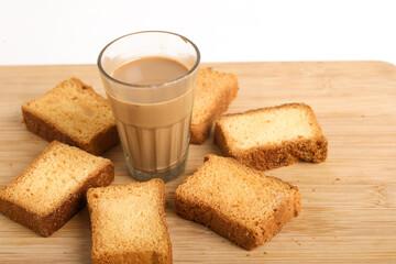 Fototapeta na wymiar rusk with cup of tea with wood background