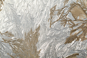 Winter snowy frosty patterns on the glass window. Winter magic. Frosty wonders. Abstract patterns.