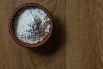 bowl of flour on wooden table with copy space