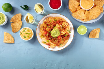 Nachos with tequila and various dips, shot from the top with a place for text