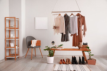 Rack with clothes in interior of modern room