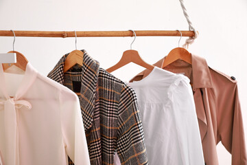 Rack with modern clothes in room, closeup