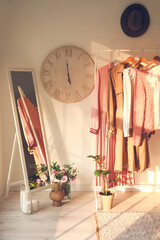 Rack with clothes in interior of modern room