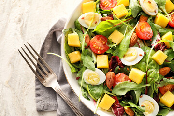 Plate of fresh mango salad on light background