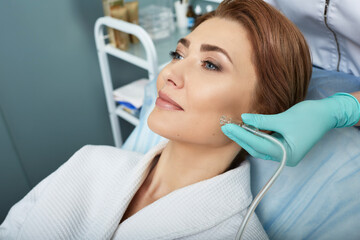 Facial ozone therapy for woman's face rejuvenation at a beauty salon. Oxygen treatment for skin