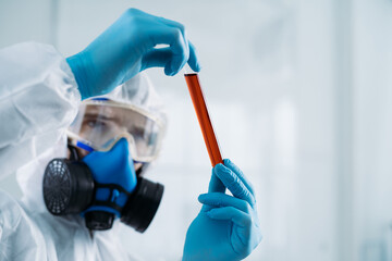 flask with a biologically dangerous substance in the hands of a researcher