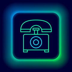 Glowing neon line Telephone icon isolated on black background. Landline phone. Colorful outline concept. Vector