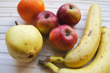 natural fruits on a wooden background. healthy food, apples and bananas