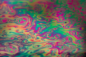 The colorful close-up surface of a soap bubble with weird psychedelic background and patterns.
Vivid rainbow colors in weird and strange patterns. 