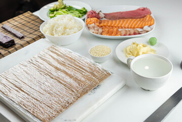 Close up of sushi chef hands preparing japanese food. Man cooking sushi at restaurant. Traditional asian seafood rolls on cutting board.