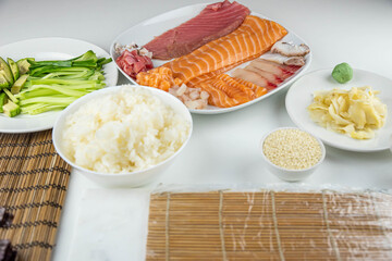 Close up of sushi chef hands preparing japanese food. Man cooking sushi at restaurant. Traditional asian seafood rolls on cutting board.