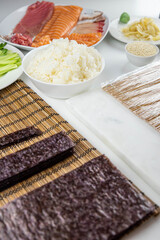 Close up of sushi chef hands preparing japanese food. Man cooking sushi at restaurant. Traditional asian seafood rolls on cutting board.