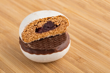 Cookies in cut with berry marmalade, on wooden background. Close-up. Copy of space