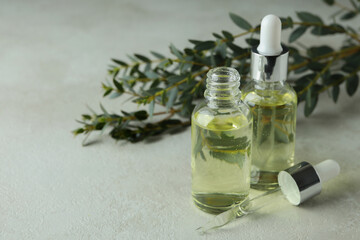 Concept of natural cosmetics with eucalyptus oil on white textured table