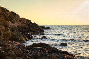 Rocks and water at Golden Bay at sunset on a warm fall evening in Malta.