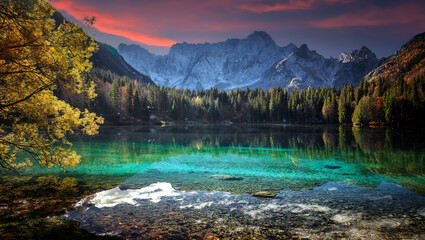 Fantastic Vivid nature landscape. Scenic image of Fusine lake during sunset. Popular travel and hiking destination. Picture of wild area. Awesome nature Background. Concept of an ideal resting place.