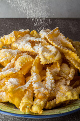 Carrot-flavored fried sheets. Dough of flour and boiled carrots, pulled with a pasta machine and fried in oil sprinkled with icing sugar