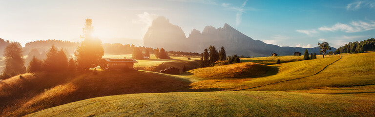 Scenic image of Autumn scenery in mountains. Fantastic Vivid nature landscape. Mountain valley during sunset. Alpe di siusi, Popular travel and hiking destination. Picture of rural area.