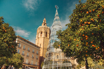 A street during the day in the city of Valencia with Christmas decorations