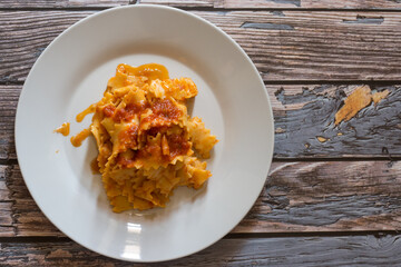 Homemade carrot pasta with flour and boiled carrots with vegetarian ragout.