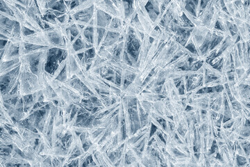 Ice background texture. Frozen water in various geometric abstract shapes. Seasonal natural effect. Cold weather. The surface of the winter water reservoir.