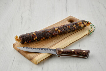 Beef sun-dried sausage on cutting board
