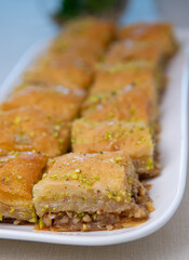 Baklawa on a plate on a table, top view, baklava, feast treat ramadan traditional dessert, High quality photo