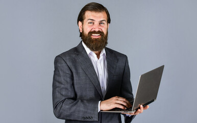 writing message. online education concept. go shopping online. confident businessman with laptop. brutal male with beard in suit. handsome ceo hold computer. boss and employee. agile business