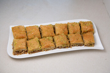Baklawa on a plate on a table, top view, baklava, feast treat ramadan traditional dessert, High quality photo
