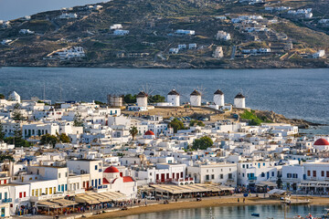 Beautiful close view of Mykonos, Cyclades, Greece, and its famous white windmills. Whitewashed houses. Vacations, leisure, Mediterranean lifestyle