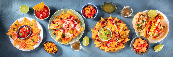 Mexican food panorama with nachos and tequila