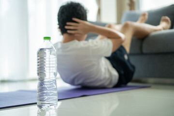 Unrecognizable Asian young man making a sit up workout