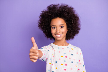 Photo of pretty brunette little afro american girl like thumb up wear white pullover isolated on violet color background