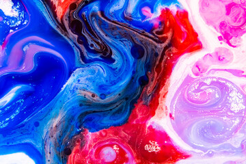 Fototapeta premium Abstract Shades in a wallpaper background. Multicolored beautiful oil paints in fantastic motion. Chaotic Movement of blue, red and magenta, and black colors.