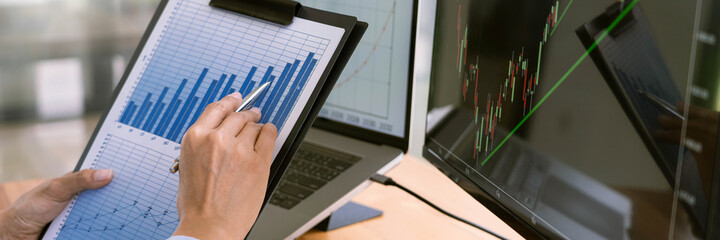 Stock Market Broker in formalwear Analyzing Graphs on  screens in the office, investment concept.