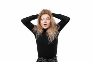 Fototapeta premium Scared and worried young blonde woman panicking, holding hands on head and look nervous, standing over white background