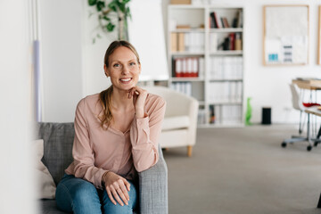 Friendly attentive young woman with a warm beaming smile