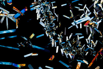 Colorful microscopic view of Epsom Salt or Magnesium Sulfate heptahydrate Crystals. Abstract background texture.  captured under polarized light with a microscope.