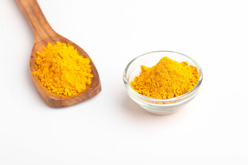 Turmeric in wooden spoon on white background.