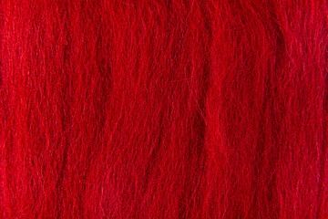 Macro microscopic photography of red wool texture. A cozy and warm image with rich color and softness.