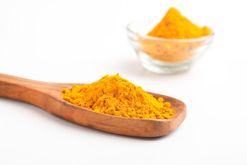 Turmeric in wooden spoon on white background.