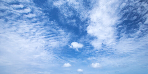 blue sky background with tiny clouds