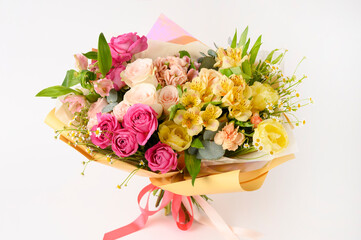 Beautiful flowers in vase on a table with white background. Women's, mother's day, love concept. Spring, summer season.