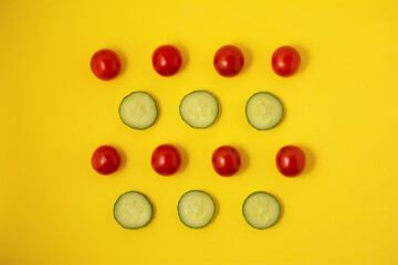 Pattern red tomato and green cucumber on a yellow background