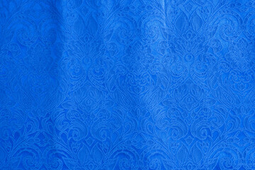 Background is made of blue textile material abstract tapestry drawing, the texture of a piece of clothing.