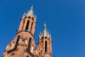 Cathedral Basilica of the Assumption of the Blessed Virgin Mary in Białystok city. Baroque style architecture. Heaven blue sky background. Red brick church in Poland.