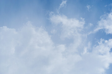 Fototapeta premium Beautiful view of blue sky with clouds. Beautiful shapes, partly cloudy. Colorful sunset. Natural sky background texture, beautiful color. Bright landscape in the blue sky